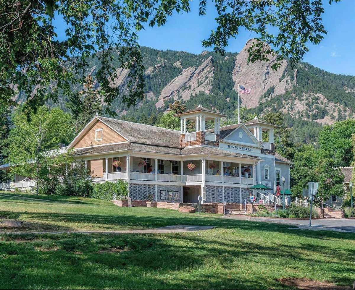 The historic Chautauqua Dining Hall with the Flatirons rising behind it.